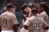San Diego Padres pitcher Nick Pivetta, center, reacts before exiting during the fourth inning of a baseball game against the Colorado Rockies Sunday, April 12, 2026, in San Diego. (AP Photo/Gregory Bull)