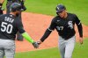 Chicago White Sox' Dustin Harris (37) celebrates with Lenyn Sosa (50) after scoring on a wild pitch by Kansas City Royals relief pitcher John Schreiber during the seventh inning of a baseball game Sunday, April 12, 2026, in Kansas City, Mo. (AP Photo/Charlie Riedel)