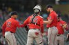 Boston Red Sox starter Garrett Crochet, front right, hands the ball to manager Alex Cora (13) for a pitching change during the second inning of a baseball game against the Minnesota Twins, Monday, April 13, 2026, in Minneapolis. (AP Photo/Abbie Parr)