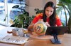 Artist Lili Cantero paints a soccer ball with images commemorating Spain's 2010 World Cup victory as part of the launch of the Wynwood United Soccer Ball Art Trail, which will showcase hand-painted soccer balls honoring historic World Cup championships inside local businesses, April 8, 2026, at Rodilla cafe in the Wynwood district of Miami. (AP Photo/Rebecca Blackwell)