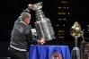 FILE - Retired NHL player Ray Bourque places the Stanley Cup on a table during a ceremony to honor members of the Colorado Avalanche's 2001 championship team that featured Bourque before an NHL hockey game against the Philadelphia Flyers, Jan. 23, 2026, in Denver. (AP Photo/David Zalubowski, File)
