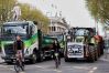 Cyclists ride past tractors blocking O'Connell Street on the fifth day of the National Fuel Protest, in Dublin, Ireland, Saturday, April 11, 2026. (AP Photo/Peter Morrison)