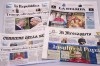 This picture, taken Tuesday, April 14, 2026, shows the front pages of some Italian newspapers reporting on comments by U.S. President Donald Trump about Pope Leo XIV, with headlines using words such as 
