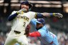 Toronto Blue Jays' Vladimir Guerrero Jr., right, tags out Milwaukee Brewers' Joey Ortiz during the eighth inning of a baseball game Tuesday, April 14, 2026, in Milwaukee. (AP Photo/Aaron Gash)