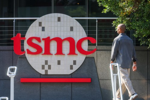 FILE -A worker walks past the logo of TSMC or Taiwan Semiconductor Manufacturing Corp., a Taiwanese multinational semiconductor contract manufacturing and design company, in Hsinchu, Taiwan, on Thursday, Jan. 29, 2026. (AP Photo/Daniel Ceng, File)