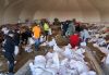 Volunteers prepare sandbags during flooding in Peguis First Nation, Man., on Wednesday, May 04, 2022. THE CANADIAN PRESS/David Lipnowski