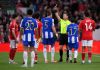 Porto's Jan Bednarek, center, is shown a red card and sent off by referee Danny Makkelie during the Europa League quarterfinal second leg soccer match between Nottingham Forest and Porto in Nottingham, England, Thursday April 16, 2026. (Gary Oakley/PA via AP)