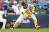 Milwaukee Brewers' Joey Ortiz hits a sacrifice bunt allowing Garrett Mitchell to score during the seventh inning of a baseball game against the Toronto Blue Jays, Thursday, April 16, 2026, in Milwaukee. (AP Photo/Kayla Wolf)