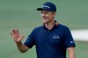Justin Rose, of England, waves after his putt on the 10th hole during the final round of the Masters golf tournament at the Augusta National Golf Club, Sunday, April 12, 2026, in Augusta, Ga. (AP Photo/Eric Gay)