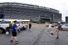 FILE - Fans play with a ball outside the Metlife Stadium prior to the Club World Cup final soccer match between Chelsea and PSG in East Rutherford, N.J., Sunday, July 13, 2025. (AP Photo/Pamela Smith, File)