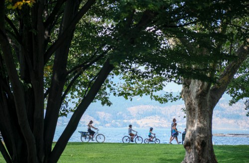 A family cycles along Lake Okanagan in Kelowna, B.C.., Wednesday, Aug. 31, 2022. THE CANADIAN PRESS/Jeff McIntosh