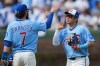 Chicago Cubs' Dansby Swanson (7) and Seiya Suzuki (27) celebrate their team's win over the New York Mets in a baseball game Friday, April 17, 2026, in Chicago. (AP Photo/Erin Hooley)