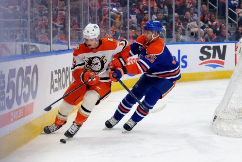 Anaheim Ducks’ Leo Carlsson (91) is chased along the boards by Edmonton Oilers’ Darnell Nurse (25) during first period NHL action in Edmonton on Saturday March 28, 2026. THE CANADIAN PRESS/James Maclennan