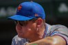 New York Mets manager Carlos Mendoza stands stands in the dugout during the first inning of a baseball game against the Chicago Cubs, Friday, April 17, 2026, in Chicago. (AP Photo/Erin Hooley)