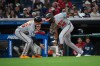 Baltimore Orioles' Jeremiah Jackson (82) is congratulated by third base coach Buck Britton, left, after hitting a three tun home run off Cleveland Guardians relief pitcher Connor Brogdon during the eighth inning of a baseball game, Friday, April 17, 2026, in Cleveland. (AP Photo/Phil Long)