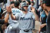 Miami Marlins' Graham Pauley, center, high-fives teammates in the dugout after scoring a run in the second inning of a baseball game against the Atlanta Braves, Tuesday, April 14, 2026, in Atlanta. (AP Photo/Colin Hubbard)