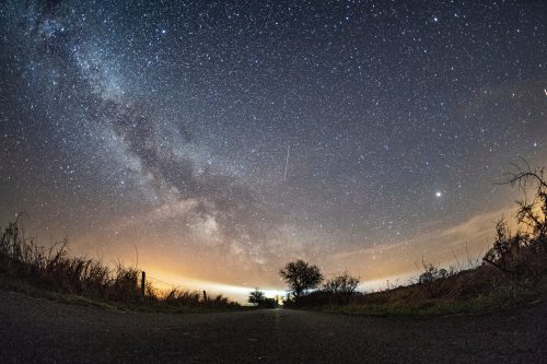 FILE - The milky way and traces of meteors illuminate the sky over Burg on the Baltic Sea island of Fehmarn, northern Germany, April 20, 2018. (Daniel Reinhardt/dpa via AP, File)