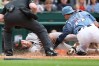 San Francisco Giants' Jung Hoo Lee is tagged out at home plate by Washington Nationals catcher Drew Millas while attempting to score on double hit by San Francisco Giants' Heliot Ramos against pitcher Cade Cavalli during the second inning of a baseball game, Saturday, April 18, 2026, in Washington. (AP Photo/Terrance Williams)