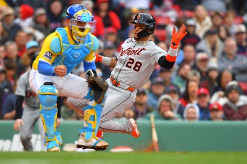 Detroit Tigers' Javier Báez (28) slides safe at home on a single by Kevin McGonigle as Boston Red Sox catcher Connor Wong, left, waits for the ball in the fourth inning of a baseball game, Saturday, April 18, 2026, in Boston. (AP Photo/Steven Senne)