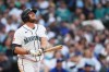 Seattle Mariners' Luke Raley follows through on a solo home run against the Texas Rangers during the sixth inning of a baseball game, Saturday, April 18, 2026, in Seattle. (AP Photo/Lindsey Wasson)