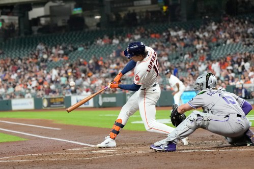 Houston Astros' Joey Loperfido (10) hits a RBI single as Colorado Rockies catcher Hunter Goodman (15) reaches for the pitch during the first inning of a baseball game Thursday, April 16, 2026, in Houston. (AP Photo/David J. Phillip)
