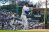 Chicago Cubs' Nico Hoerner, foreground, walks to first during the first inning of a baseball game against the New York Mets in Chicago, Sunday, April 19, 2026. (AP Photo/Nam Y. Huh)