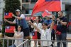 Members of Taiwan's main opposition Nationalist Party, or Kuomintang (KMT), wave national flags in front of the party's headquarters in Taipei, Taiwan on Tuesday, April 14, 2026. (AP Photo/Chiang Ying-ying)