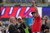 Cleveland Guardians catcher Austin Hedges, right, gestures after proposing to Lexi Dickinson, left, after a baseball game against the Baltimore Orioles in Cleveland, Sunday, April 19, 2026. (AP Photo/Sue Ogrocki)
