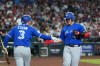 Toronto Blue Jays' Kazuma Okamoto, right, of Japan, celebrates his home run against the Arizona Diamondbacks with Blue Jays' Myles Straw (3) during the third inning of a baseball game, Sunday, April 19, 2026, in Phoenix. (AP Photo/Ross D. Franklin)