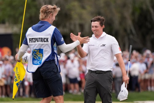 Matt Fitzpatrick, of England, right, celebrates with caddie Daniel Parratt after winning the RBC Heritage golf tournament Sunday, April 19, 2026, in Hilton Head, S.C. (AP Photo/Mike Stewart)