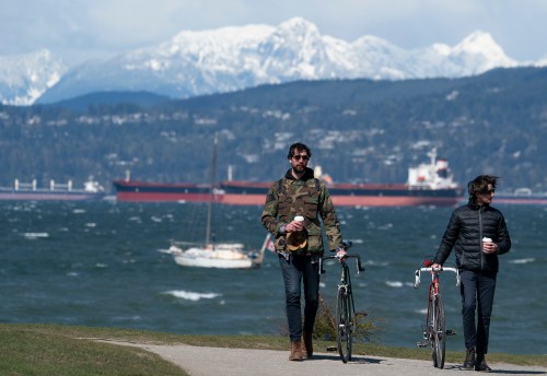 People enjoy the sunny but windy weather in Vancouver, B.C., Saturday, April 10, 2021. THE CANADIAN PRESS/Jonathan Hayward