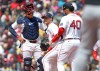 Boston Red Sox' startng pitcher Sonny Gray, center, is visited on the mound by teammates Carlos Narvaez, left, and Willson Contreras after appearing to injure himself in the third inning during a baseball game against the Detroit Tigers, Monday, April 20, 2026 in Boston. He would leave the game with the injury. (AP Photo/Jim Davis)