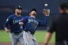 Seattle Mariners second baseman Brendan Donovan, center, makes the catch for the out on San Diego Padres' Xander Bogaerts as starting pitcher Luis Castillo looks on, left, during the second inning of a baseball game Thursday, April 16, 2026, in San Diego. (AP Photo/Gregory Bull)