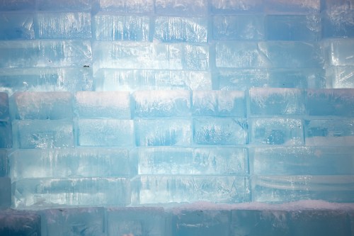 People gather around blocks of ice, installed in a Toronto parking lot as part of promotion for rapper Drake's upcoming album 