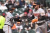 Baltimore Orioles' Gunnar Henderson, right, celebrates with Adley Rutschman after scoring on a one-run double by Taylor Ward during the third inning of a baseball game against the Chicago White Sox in Chicago, Wednesday, April 8, 2026. (AP Photo/Nam Y. Huh)