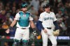 Seattle Mariners catcher Cal Raleigh stands near the plate with relief pitcher Casey Legumina, right, after Athletics' Tyler Soderstrom scored during the eighth inning of a baseball game, Monday, April 20, 2026, in Seattle. (AP Photo/Lindsey Wasson)