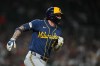 Milwaukee Brewers' Brice Turang runs out a one-run single against the Detroit Tigers during the seventh inning of a baseball game Tuesday, April 21, 2026, in Detroit. (AP Photo/Paul Sancya)