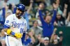 Kansas City Royals' Maikel Garcia celebrates after scoring the game-winning run on a wild pitch thrown by Baltimore Orioles relief pitcher Ryan Helsley during the ninth inning of a baseball game Tuesday, April 21, 2026, in Kansas City, Mo. (AP Photo/Charlie Riedel)