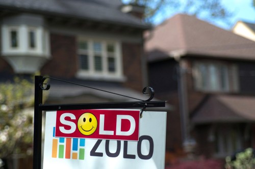 A sold sign is shown in front of a west-end Toronto home, Sunday, May 14, 2017. THE CANADIAN PRESS/Graeme Roy