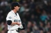 Seattle Mariners starting pitcher Logan Gilbert tries to fish out the ball after Athletics' Carlos Cortes hit a line drive base hit into his jersey during the first inning of a baseball game, Wednesday, April 22, 2026, in Seattle. (AP Photo/Lindsey Wasson)