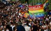 People march across the Szabadsag, or Freedom Bridge over the River Danube in downtown Budapest during a gay pride parade in Budapest, Hungary, Saturday, July 24, 2021. Rising anger over policies of Hungary's right-wing government filled the streets of the country's capital on Saturday as thousands of LGBT activists and supporters marched in the city's Pride parade. (AP Photo/Anna Szilagyi)