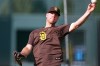 San Diego Padres first baseman Gavin Sheets warms up before a baseball game against the Colorado Rockies Tuesday, April 21, 2026, in Denver. (AP Photo/David Zalubowski)