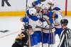 Buffalo Sabres right wing Alex Tuch (89) celebrates his goal with teammates as Boston Bruins defenseman Hampus Lindholm (27) skates past during the third period in Game 3 of a first-round NHL hockey Stanley Cup playoff series, Thursday, April 23, 2026, in Boston. (AP Photo/Charles Krupa)