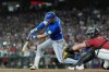 Toronto Blue Jays' Nathan Lukes, left, connects for a three-run double as Arizona Diamondbacks catcher James McCann reaches for the ball during the first inning of a baseball game, Sunday, April 19, 2026, in Phoenix. (AP Photo/Ross D. Franklin)