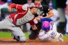 Kansas City Royals' Isaac Collins (1) beats the tag by Los Angeles Angels catcher Logan O'Hoppe to score on a two-run double hit by Elias Diaz during the fourth inning of a baseball game Friday, April 24, 2026, in Kansas City, Mo. (AP Photo/Charlie Riedel)