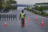 A police officer stands to divert traffic on a road barricaded by authorities due to security arrangements for possible second round of talks between the U.S. and Iran, in Islamabad, Pakistan, Friday, April 24, 2026. (AP Photo/M.A. Sheikh)