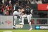 Miami Marlins shortstop Otto Lopez (6) celebrates with second baseman Xavier Edwards after a baseball game against the San Francisco Giants in San Francisco, Friday, April 24, 2026. (AP Photo/Jeff Chiu)