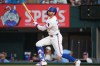 Texas Rangers' Brandon Nimmo watches his ball as he hits a sacrifice fly ball to score Danny Jansen during the third inning of a baseball game against the Athletics, Saturday, April 25, 2026, in Arlington, Texas. (AP Photo/Julio Cortez)