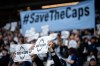 Vancouver Whitecaps fans hold signs before the first half of an MLS soccer match against the Colorado Rapids in Vancouver, on Saturday, April 25, 2026. THE CANADIAN PRESS/Ethan Cairns