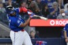 Toronto Blue Jays designated hitter Vladimir Guerrero Jr. (27) hits an RBI single against the Cleveland Guardians in first inning MLB baseball game action in Toronto on Sunday, April 26, 2026. THE CANADIAN PRESS/Jon Blacker